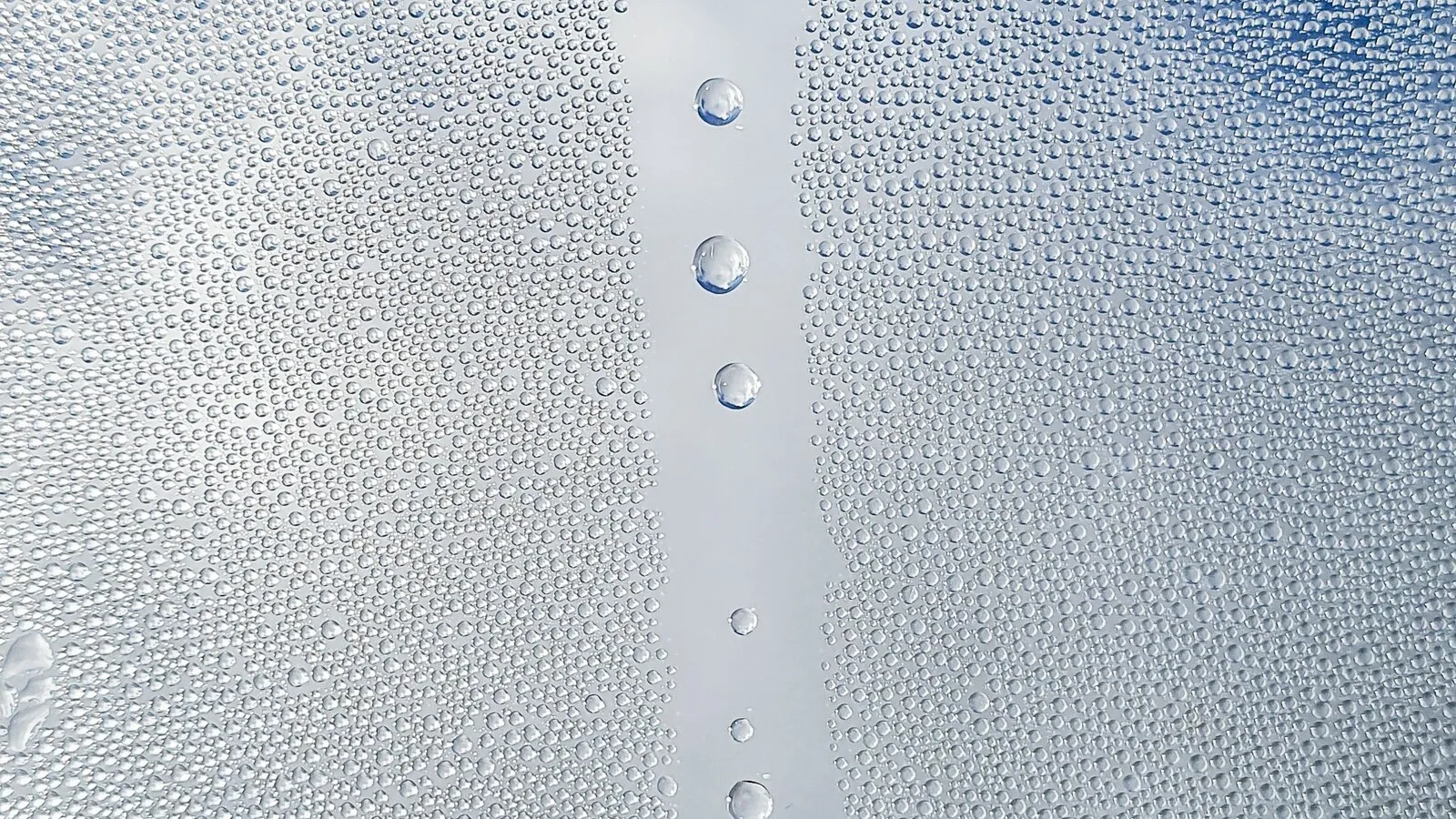 Close-up of water droplets scattered across a glass pane.