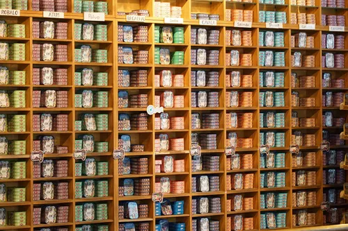 Assorted canned goods are arranged on store shelves.