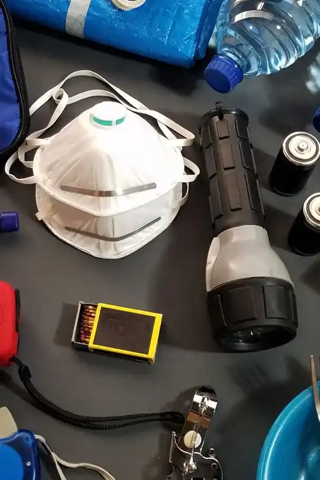 Flat lay of emergency kit items, including first-aid supplies and water bottles
