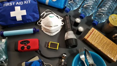 Flat lay of emergency kit items, including first-aid supplies and water bottles