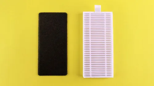 A black foam filter and a white pleated filter are shown against a yellow background.