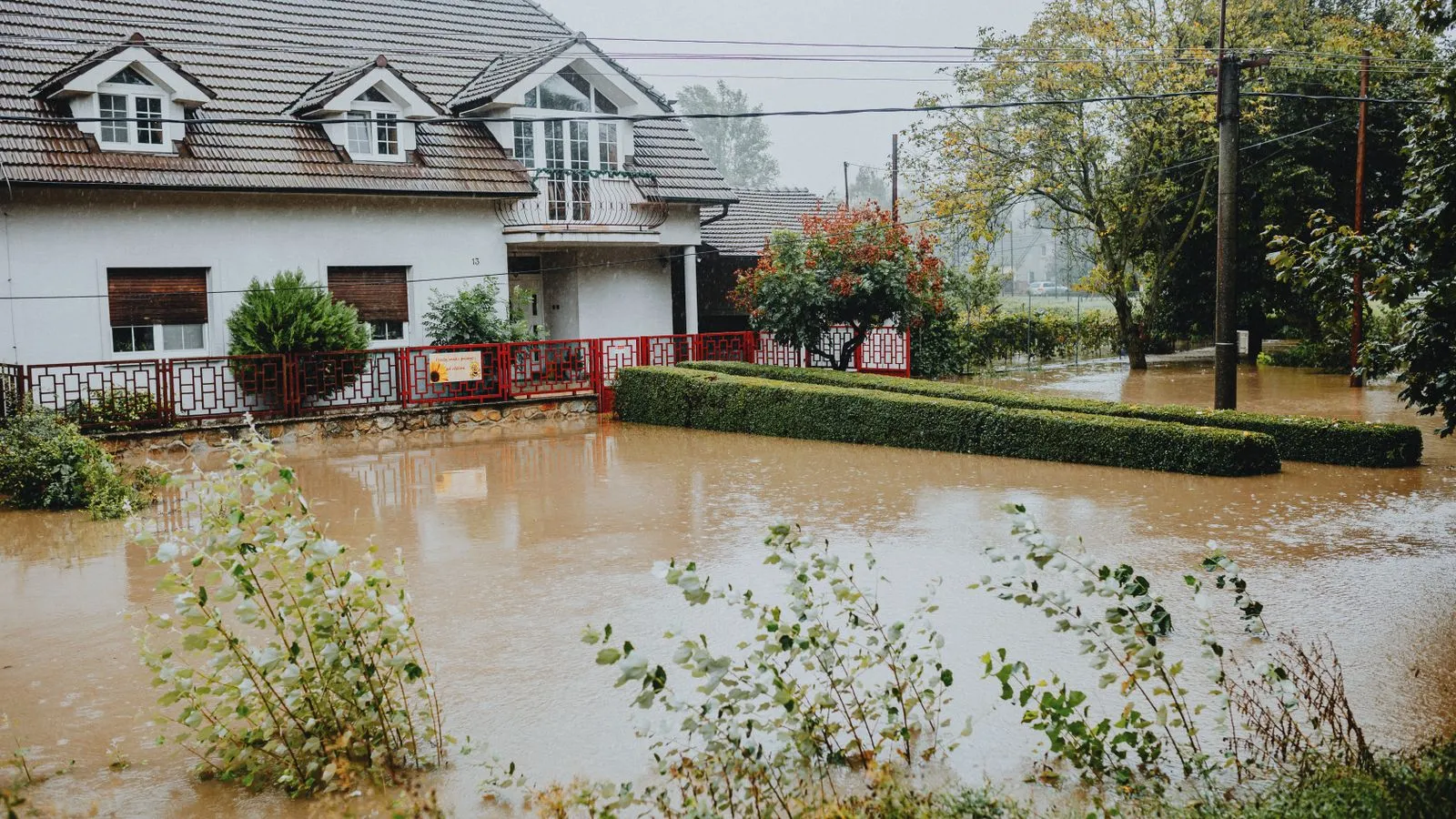 House and front yard surrounded by floodwater