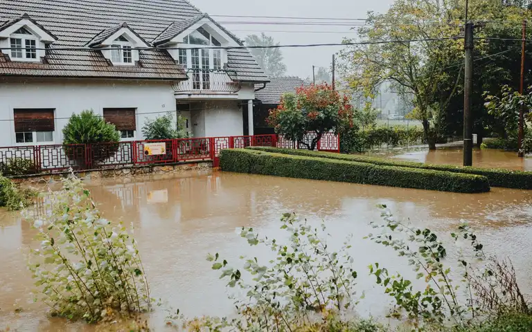 House and front yard surrounded by floodwater